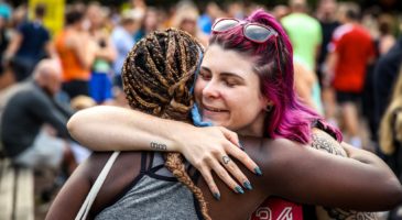 Two runners hugging